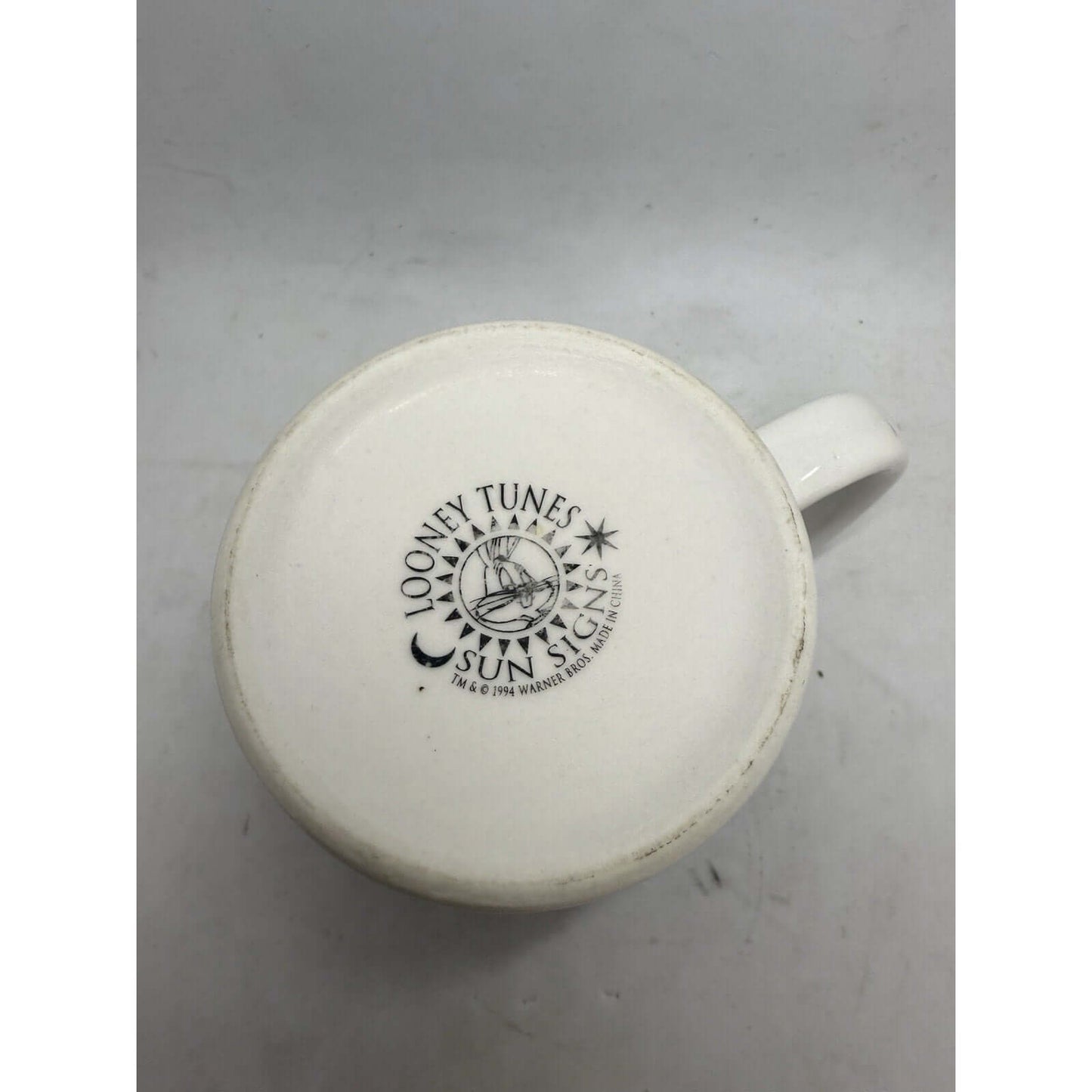 1994 Looney Tunes Sagittarius coffee cup, ceramic mug with faded logo, great for collectors of drinking cups.