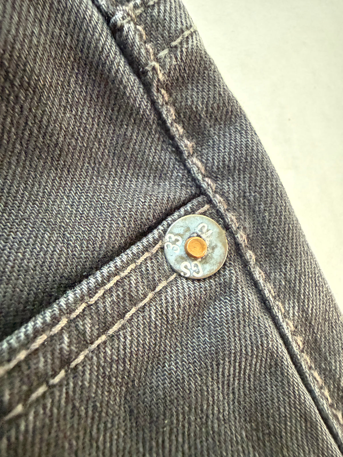 G-Star branded button rivet close up