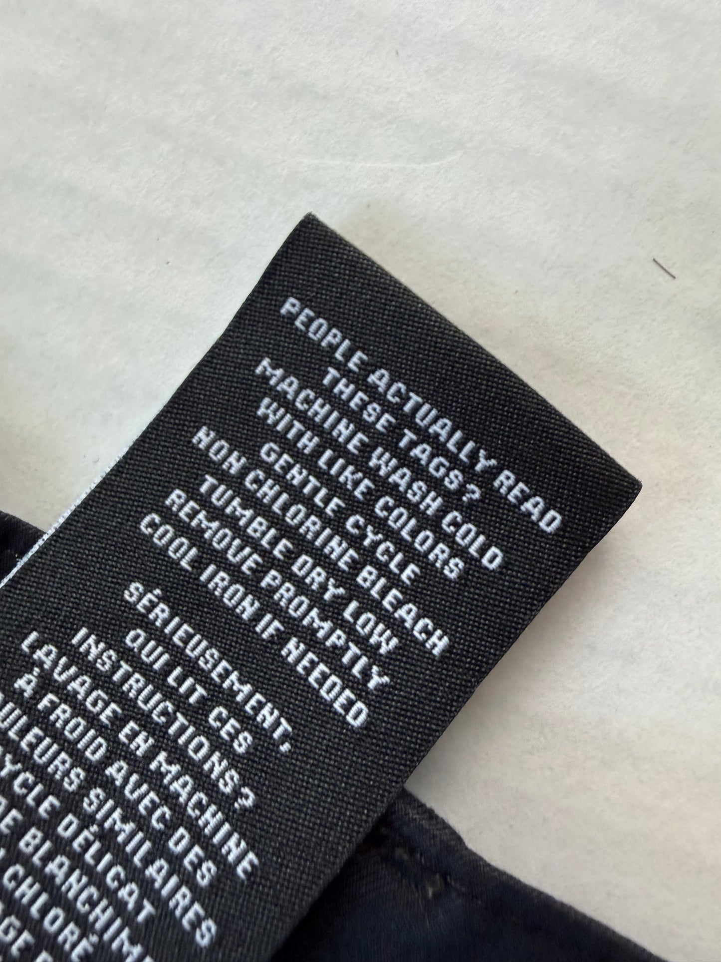TravisMathew logo button close-up