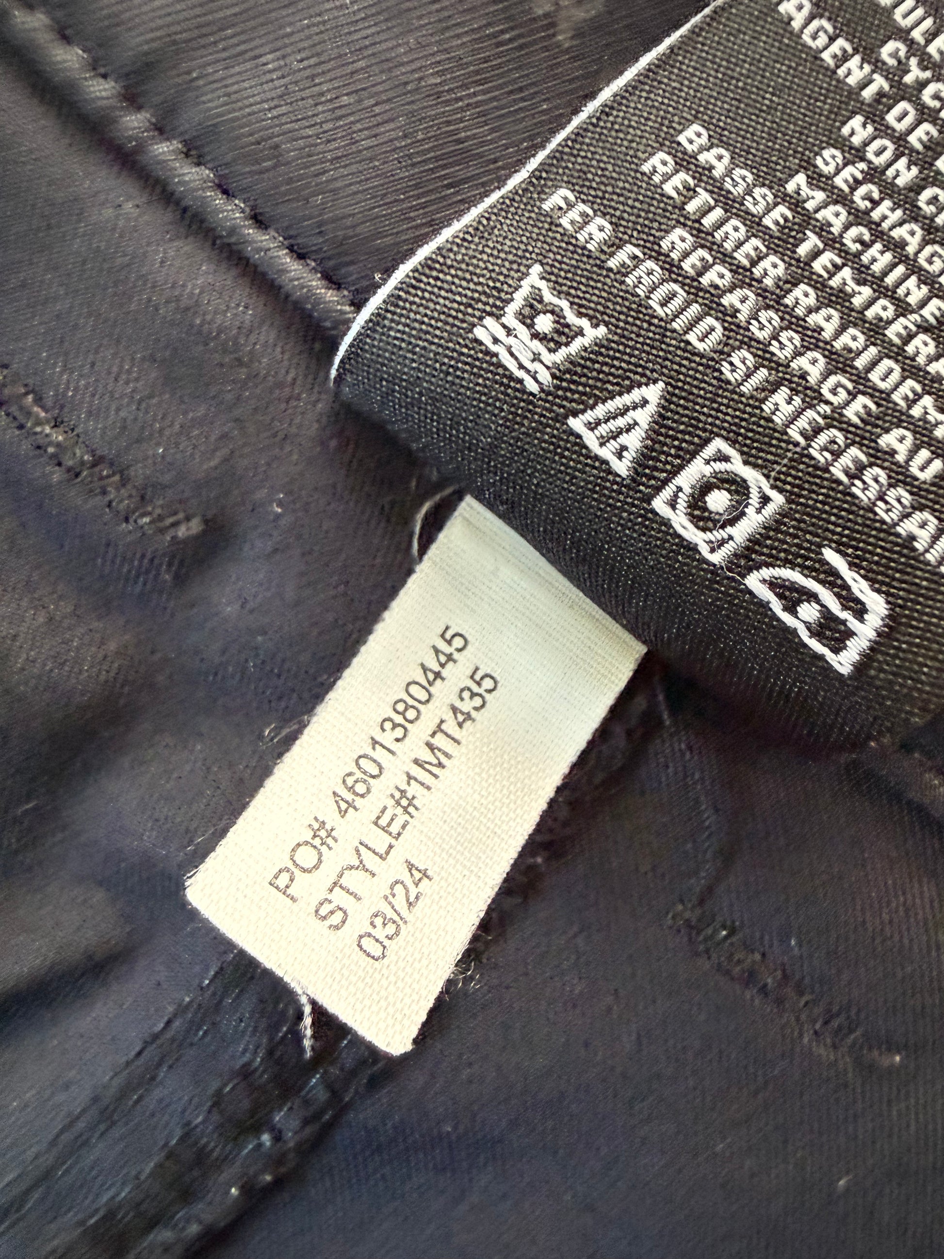 TravisMathew waistband and button detail