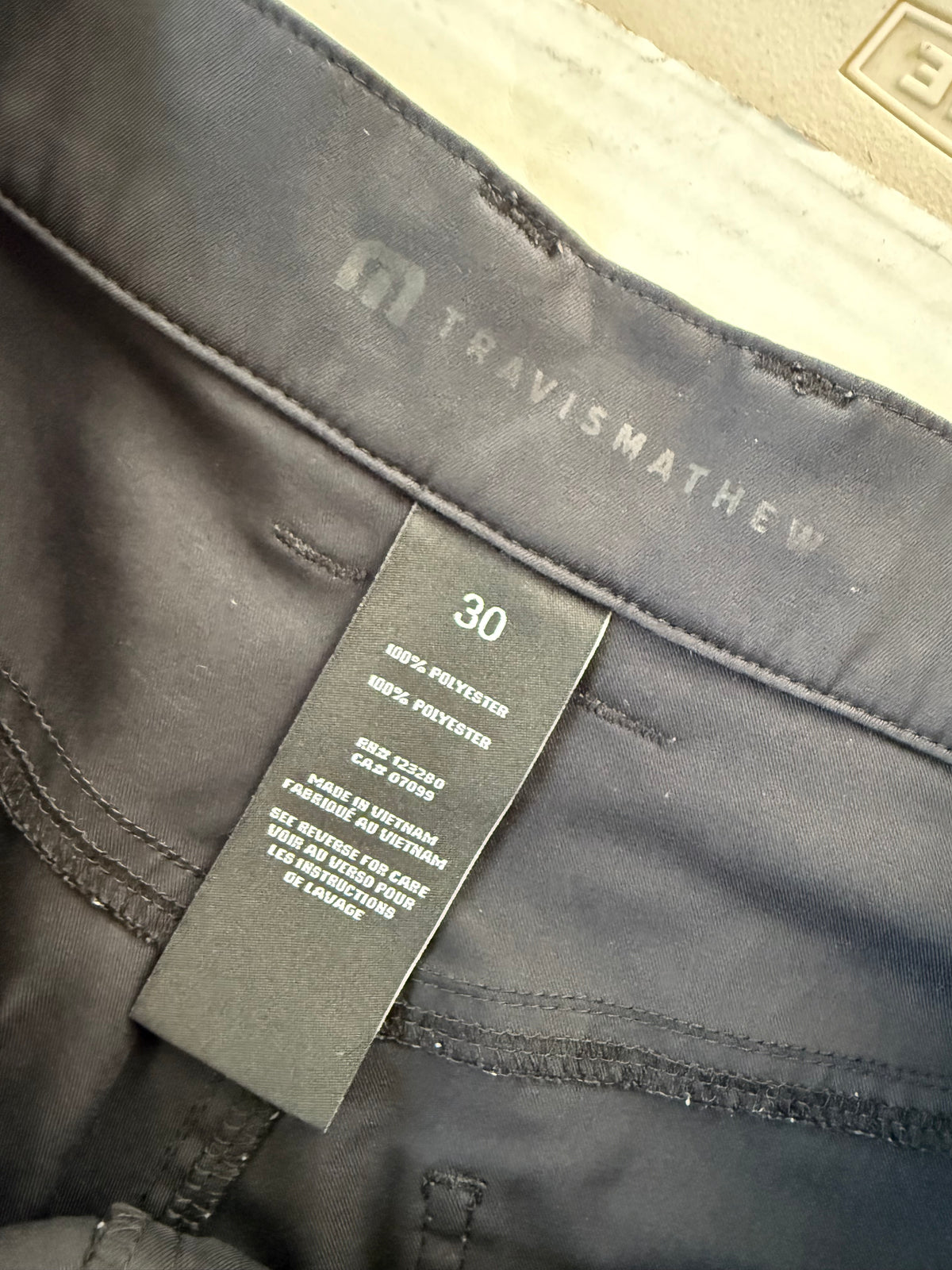TravisMathew pants size and fabric tag